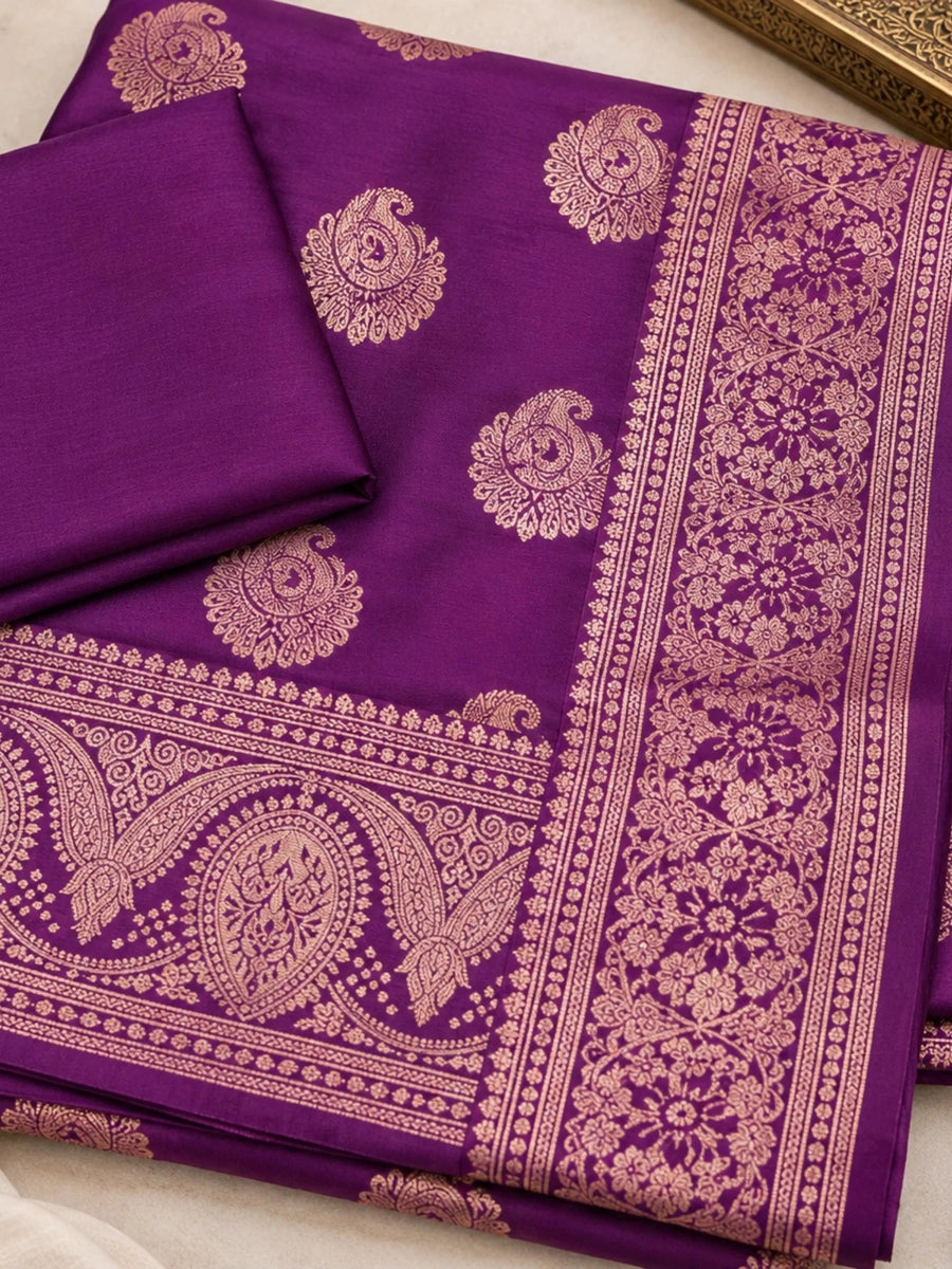 Purple silk saree with gold floral motifs and an ornate woven border on a woman.
