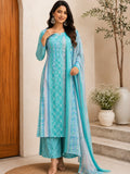 Woman wearing a turquoise printed kurta palazzo set with a matching flowing dupatta.